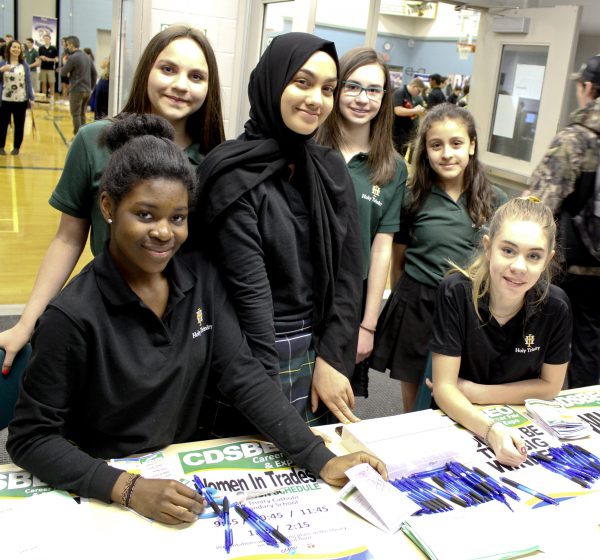 A group of students from Holy Trinity Catholic Secondary School host the Women in Trades table at the CDSBEO Career Fair in Cornwall. 
